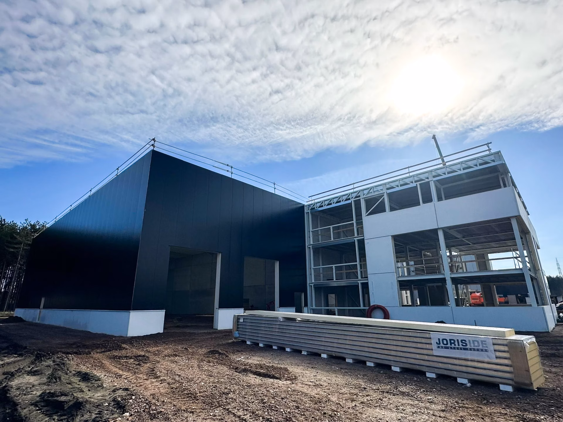 Nieuw bedrijfsgebouw voor Technical Touch Racing met magazijn, mezzanine, laadkade en kantoren, gebouwd door Derdaele+